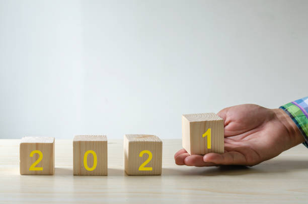 istock Hand wooden block  happy new year 2021 1297200738