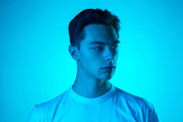 istock Handsome caucasian man's portrait isolated on blue studio background in neon light, monochrome 1297201816