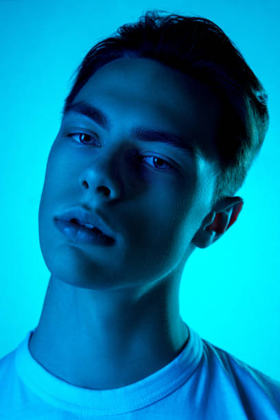 istock Handsome caucasian man's portrait isolated on blue studio background in neon light, monochrome 1297201826