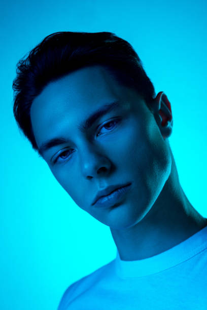 istock Handsome caucasian man's portrait isolated on blue studio background in neon light, monochrome 1297201830