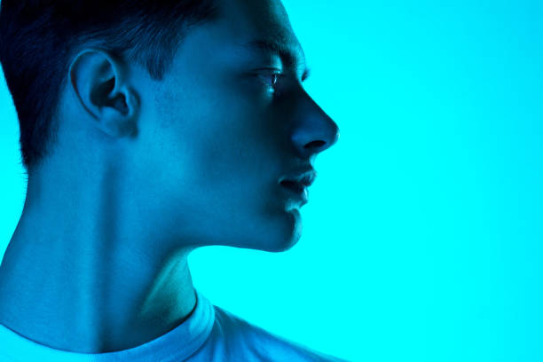 istock Handsome caucasian man's portrait isolated on blue studio background in neon light, monochrome 1297201831