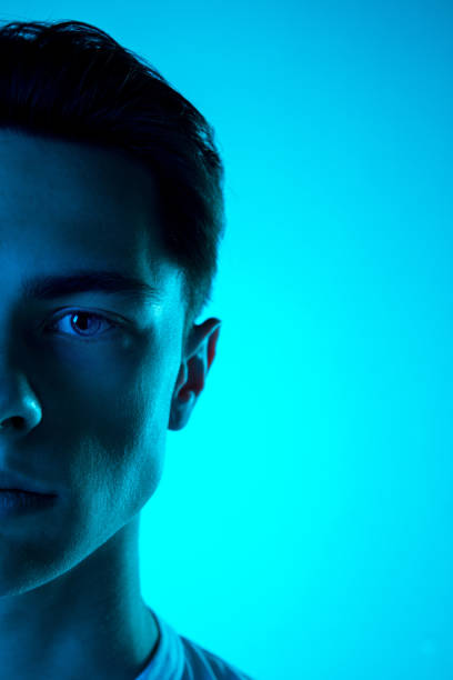 istock Handsome caucasian man's portrait isolated on blue studio background in neon light, monochrome 1297201833