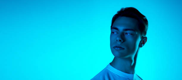istock Handsome caucasian man's portrait isolated on blue studio background in neon light, monochrome 1297201838