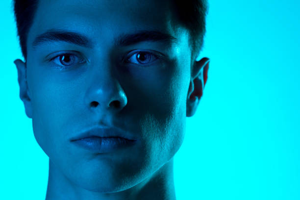 istock Handsome caucasian man's portrait isolated on blue studio background in neon light, monochrome 1297201840