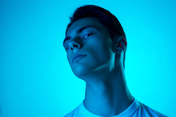 istock Handsome caucasian man's portrait isolated on blue studio background in neon light, monochrome 1297201841
