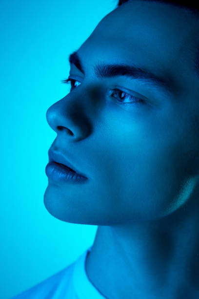 istock Handsome caucasian man's portrait isolated on blue studio background in neon light, monochrome 1297201873