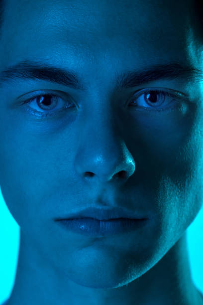 istock Handsome caucasian man's portrait isolated on blue studio background in neon light, monochrome 1297201901