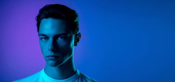 istock Handsome caucasian man's portrait isolated on purple studio background in neon light, monochrome 1297201933
