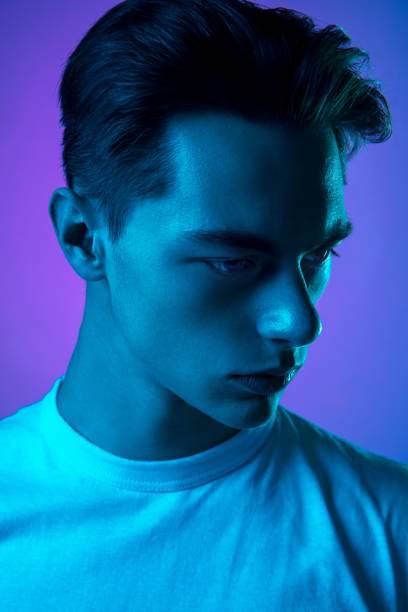 istock Handsome caucasian man's portrait isolated on purple studio background in neon light, monochrome 1297201954
