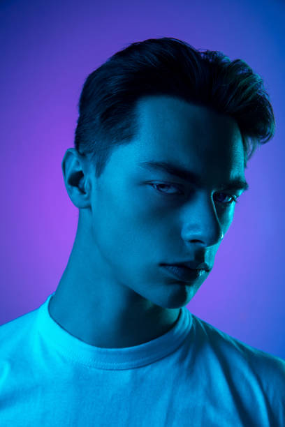 istock Handsome caucasian man's portrait isolated on purple studio background in neon light, monochrome 1297201959