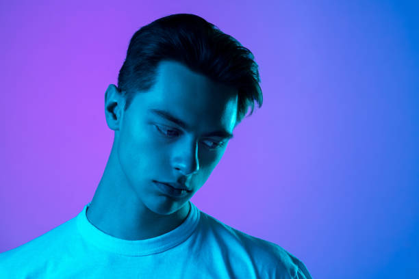 istock Handsome caucasian man's portrait isolated on purple studio background in neon light, monochrome 1297201963