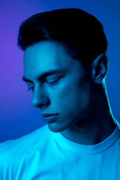 istock Handsome caucasian man's portrait isolated on purple studio background in neon light, monochrome 1297201965