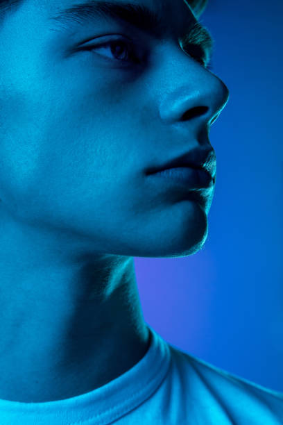 istock Handsome caucasian man's portrait isolated on purple studio background in neon light, monochrome 1297201970