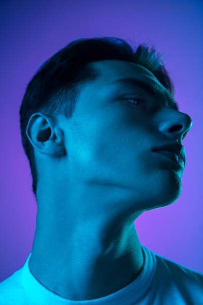 istock Handsome caucasian man's portrait isolated on purple studio background in neon light, monochrome 1297201974