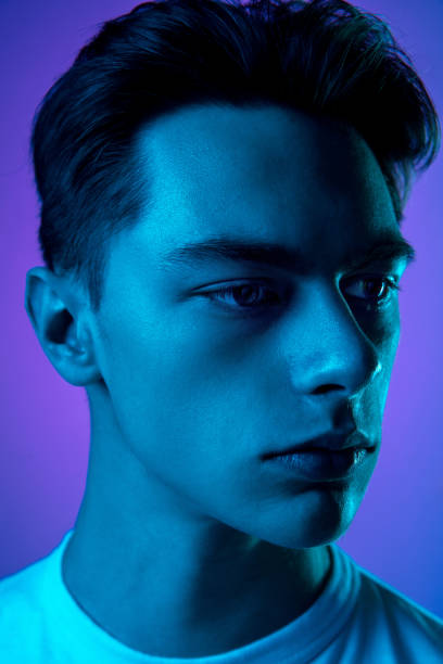 istock Handsome caucasian man's portrait isolated on purple studio background in neon light, monochrome 1297201979