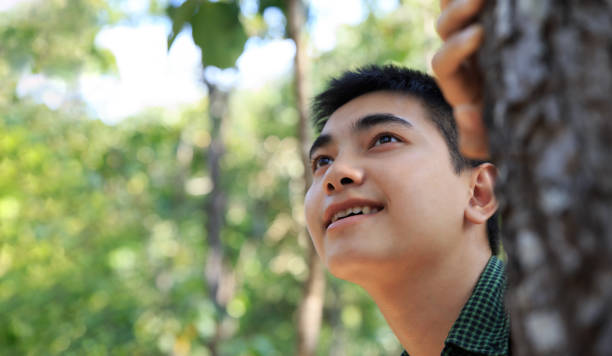 istock Asian teenager hike through forest to peak of mountain. 1297202607