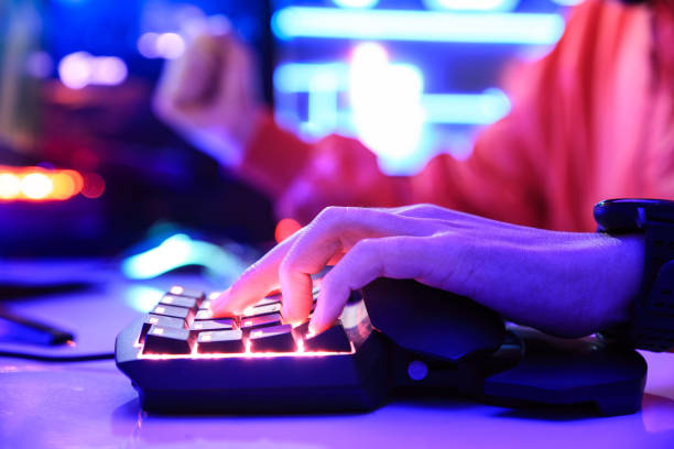 istock Gamer playing online game on PC in dark room. 1297202692