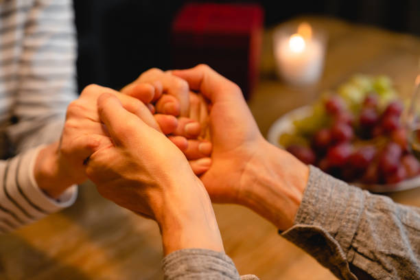 istock Cropped shot of lover`s hands holding together on a romantic dinner 1297203643