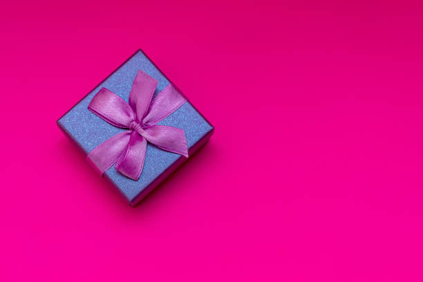 istock Gift box with ribbon on a pink background. Composition for Valentine's Day. Flat lay, copy space, top view. 1297204509