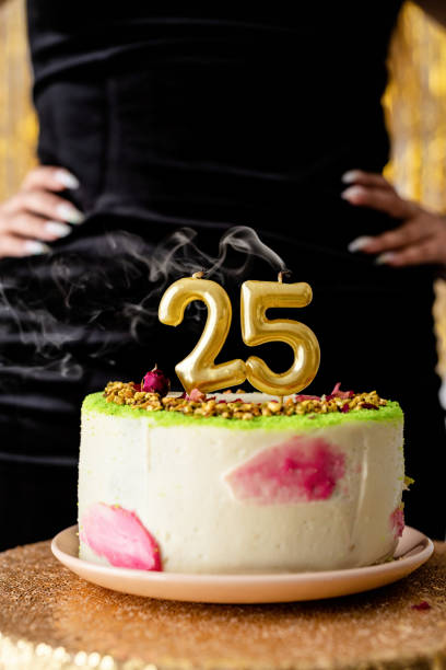 istock Golden candles 25 on birthday cake 1297205992