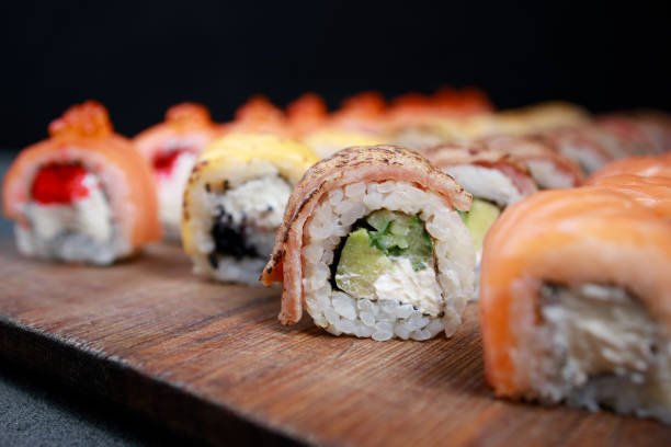 istock Seafood delicatessen sushi rolls set on board 1297206711