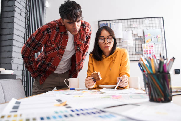istock Designer looking at the paper with sample of design 1297207397