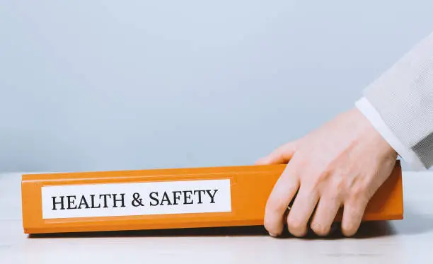 Photo of Health and safety labor protection. Folder with documents or instructions