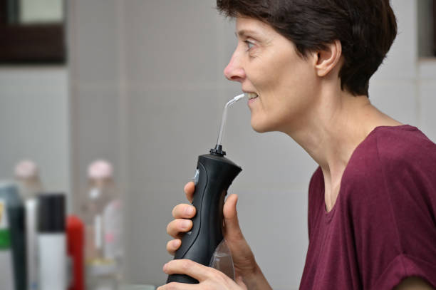 Portrait Of A Young Womanand and Professional Oral Irrigator or Flosser stock photo