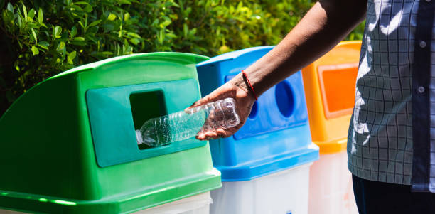 istock black hand throwing an empty plastic water bottle in the recycling garbage trash 1297210536