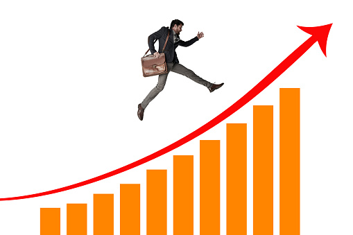 Shot of a businessman carrying a bag and running above a graph against a white background