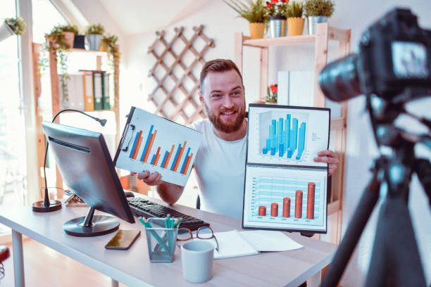 istock Smiling Male Making Video Lesson About Reading And Interpreting Graphic Charts 1297210650