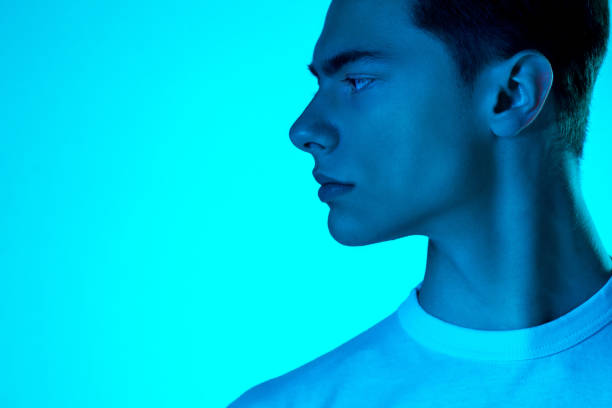 istock Handsome caucasian man's portrait isolated on blue studio background in neon light, monochrome 1297210844