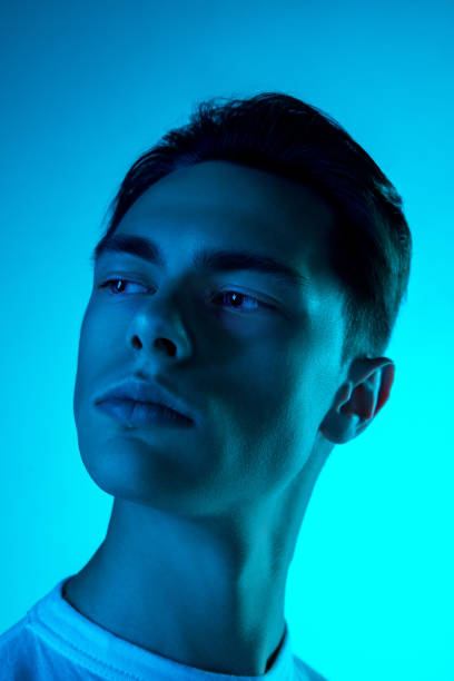 istock Handsome caucasian man's portrait isolated on blue studio background in neon light, monochrome 1297210846