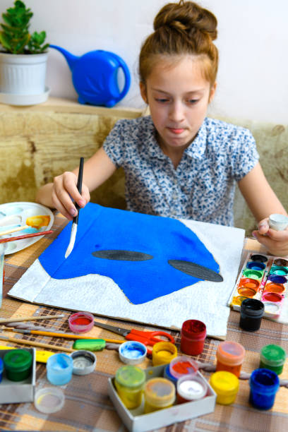 istock a girl drawing blue gouache cardboard, artistic creation at home, makes creative artwork 1297211410