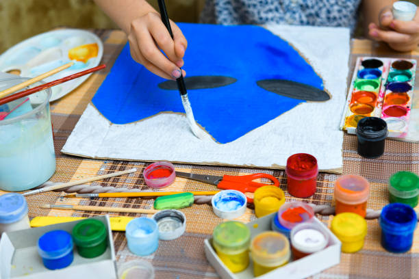 istock a girl drawing blue gouache cardboard, artistic creation at home, makes creative artwork 1297211566
