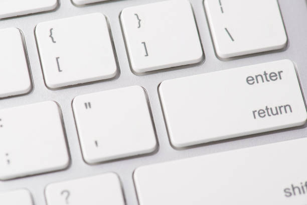 istock Close up macro photo of computer keyboard and white button enter 1297211663
