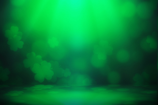 ST Patrick's day background green clover leaf bokeh lights defocused for ST Patrick's day celebration design background.