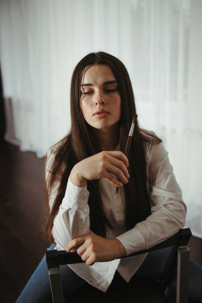 istock Young woman artist posing at home workshop 1297213299