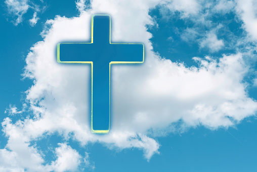 Gate to heaven. Shining cross in clouds on blue sky. Copy space. Ascension day concept. Christian Easter. Faith in Jesus Christ. Christianity. Church worship, salvation concept. Eternal life of soul.