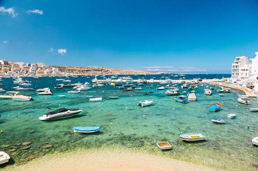 Coverack, Cornwall, UK - July 27, 2023.   Landscape view of traditional Cornish fishing boats moored in the tidal harbour of the quaint fishing village of Coverack with copy space