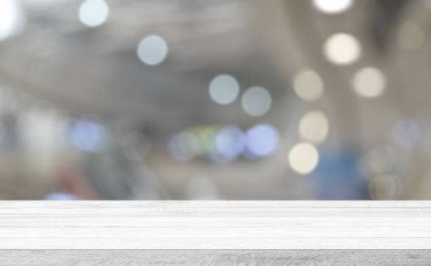 istock Empty white wood tabletop, desk over blur soft light in restaurant bokeh background 1297216147