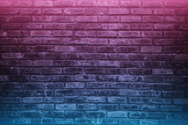 light and dark gray bricks on the wall decoration with colored led lights for background. High quality photo