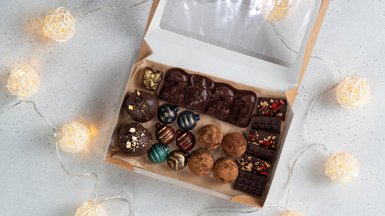 Chocolate candies, chocolate bar 2021 and truffles in a gift box.