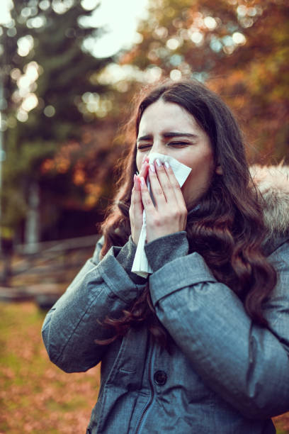istock Female Sneezing In Paper Tissue During Cold Mountain Morning 1297217120