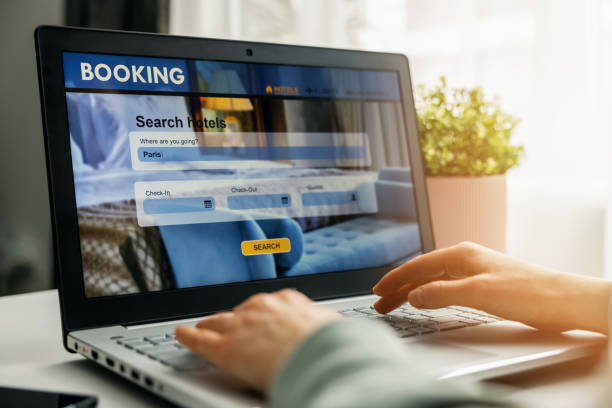 istock online booking - person using laptop for hotel search and reservation 1297217473
