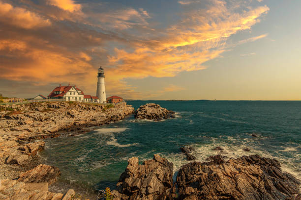 istock Portland Head Light with Rocky Cliffs, Ocean Surf and Beautiful Sunset Sky. 1297219542