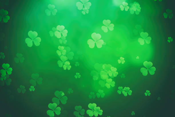 istock ST Patrick's day background green clover leaf bokeh lights defocused for ST Patrick's day celebration design background 1297221931