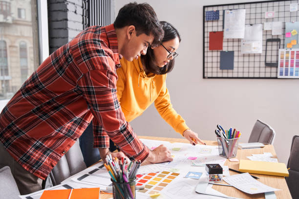 istock Designers discussing something at the office 1297221943