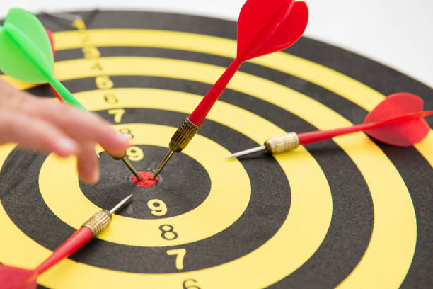 istock Close-up five dart targets on a black and yello background. Concept for success - image 1297226121