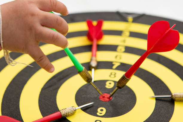 istock Close-up five dart targets on a black and yello background. Concept for success - image 1297226126